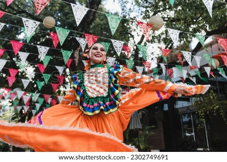 Latin woman dancer wearing traditional Mexican dress traditional from Guadalajara Jalisco Mexico Latin America, young hispanic people in independence day or cinco de mayo parade or cultural Festival Royalty-Free Stock Photo #2302749691