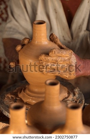 Close up hands of the traditional pottery making in the old way clay
 Royalty-Free Stock Photo #2302750877