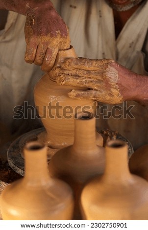 Close up hands of the traditional pottery making in the old way clay
 Royalty-Free Stock Photo #2302750901