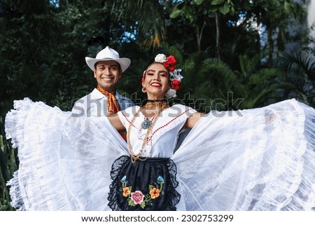 Latin couple of dancers wearing traditional Mexican dress from Veracruz Mexico Latin America, young hispanic woman and man in independence day or cinco de mayo parade or cultural Festival Royalty-Free Stock Photo #2302753299