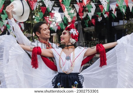 Latin couple of dancers wearing traditional Mexican dress from Veracruz Mexico Latin America, young hispanic woman and man in independence day or cinco de mayo parade or cultural Festival Royalty-Free Stock Photo #2302753301