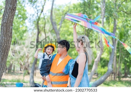 family happy in nature in summer parents and son fly a kite