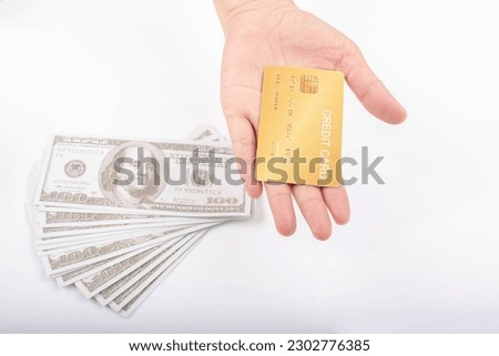 Female hand holding gold and silver credit card on white background