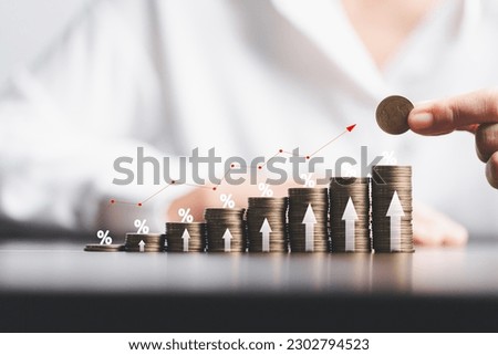Business woman hand and stack coins money with up arrow and percentage symbol of Interest rate financial and mortgage rates. Icon percentage symbol and arrow pointing up.