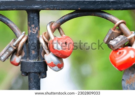 Red lock padlock love heart shape on bridge