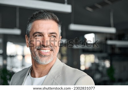 Happy middle aged business man ceo entrepreneur standing in office. Smiling mature confident professional executive manager, confident businessman leader looking away, headshot close up portrait. Royalty-Free Stock Photo #2302831077