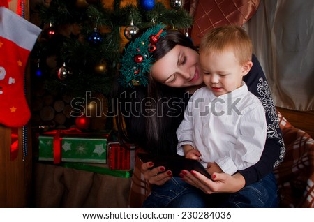 Mom and son holding a tablet PC. Watching cartoons in a festive atmosphere