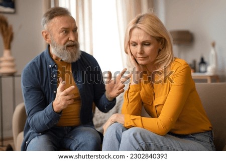 Unhappiness In Marriage. Senior Couple Having Quarrel, Husband Shouting At Upset Wife, Experiencing Tense Moments In Relationship Sitting At Home. Domestic Abuse And Conflicts. Selective Focus Royalty-Free Stock Photo #2302840393