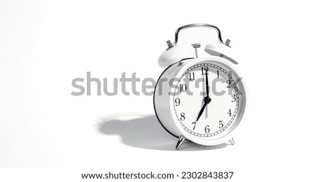 White alarm clock on a white background isolated, close-up.