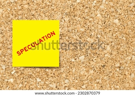 Yellow note paper with word speculation on cork board background with copy space Royalty-Free Stock Photo #2302870379