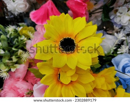 A group of different types of plastic flowers. Multicolor of plastic flowers. 