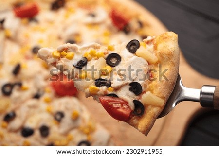 Italian or French pizza with different ingredients. Sausage, meat, cheese, tomatoes.