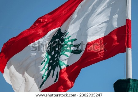 The Lebanese flag in the center of Beirut fluttering in the wind, close-up
