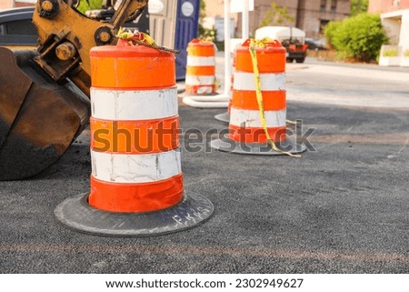 Construction cones and site symbolize work in progress, caution, and transformation. They represent ongoing construction activities, safety measures, and the potential for growth and development Royalty-Free Stock Photo #2302949627