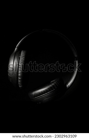 Still life of professional wireless headphones floating on a black background.