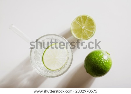 Close up of mineral water with ice and lime in glasses for refreshment in the summer top view