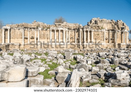 Ruins of the Nymphaeum monumental fountain in Side, Turkey. Nymphaeum, built in the 2nd century AD, lays outside the city walls opposite the city gate.  Royalty-Free Stock Photo #2302974101