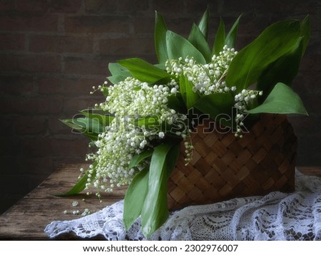 Still life with lily of the valley in a basket