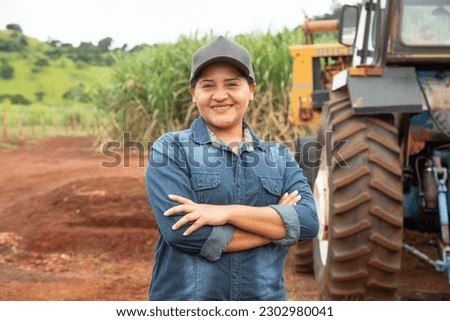 Smiling latin Brazilian woman in the farm. Joy, positive and love.Cross arms 