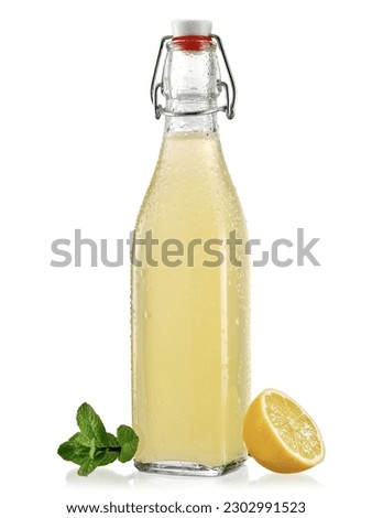 Fresh lemonade on a glass bottle with porcelain cap on white background Royalty-Free Stock Photo #2302991523