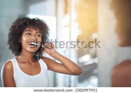 Mirror, dental and black woman brushing teeth, fresh breath and oral health in the bathroom. Female person, happy model and lady with wellness, mirror and hygiene with morning routine and tooth care Royalty-Free Stock Photo #2302997951