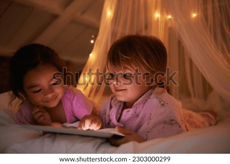 Night, bed and girls with a tablet, games and playing for fun, happiness and relax together. Female kids, children and young people with technology, entertainment and cheerful with a smile or evening