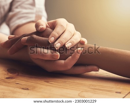 Empathy, trust and support with people holding hands as friends in solidarity in cancer pain, grief or loss. Mental health, depression and love between friends during prayer together or faith in god Royalty-Free Stock Photo #2303001229