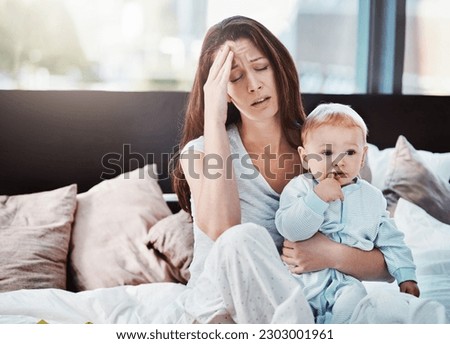 Mother, baby and tired or stress in a home bedroom or bed with postpartum, headache or anxiety. Depression, mental health and burnout of a woman or mom with a child in a family house with fatigue Royalty-Free Stock Photo #2303001961