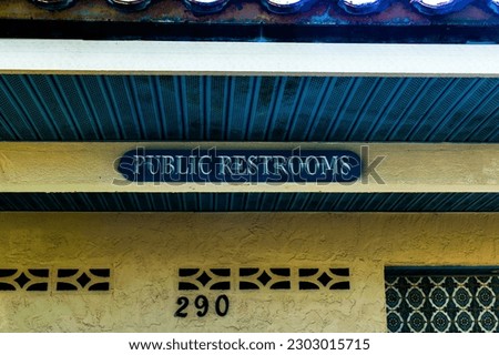 Public restroom sign on building