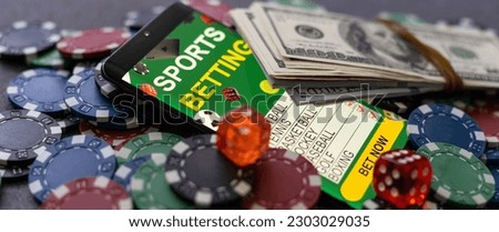 Mobile phone with bets, cards, chips, cubes and money dollars. Concept application for smartphone gambling, electronic casino online