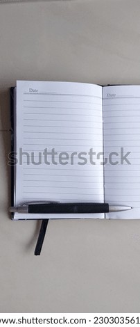 paper note book with pen on it great for background