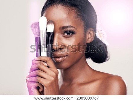 Beauty, makeup brushes and portrait of black woman with cosmetics on face in studio with application tools. Skincare, brush and cosmetic skin care model with luxury contour tool on white background.
