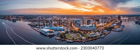 Norfolk, Virginia, USA downtown city skyline from over the Elizabeth River at dusk. Royalty-Free Stock Photo #2303040773