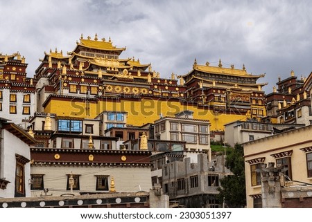 Songzanlin Temple, is Tibetan Buddhist monastery in Zhongdian city, Shangri-La, Yunnan province, China, travel and tourists, famous place and landmark, religious and holiday concept Royalty-Free Stock Photo #2303051397
