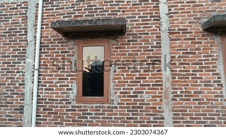 Brick house wall with riben glass windows