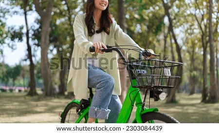 Women riding bicycle with enjoying for relaxation and exercise with healthy lifestyle in the park.