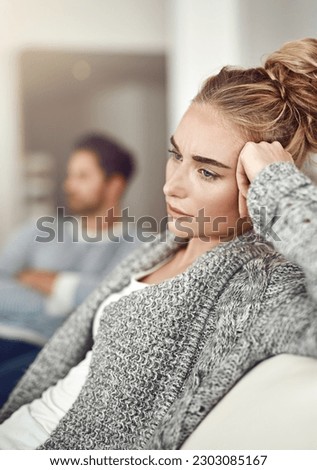 Argument, stress and sad woman in a fight with her boyfriend in the living room of their apartment. Divorce, depression and young female person with conflict or breakup i couple therapy for marriage Royalty-Free Stock Photo #2303085167