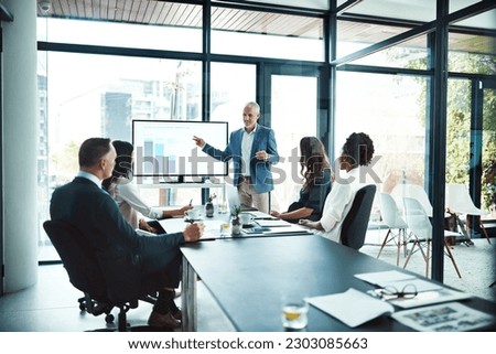 Business, charts and man with presentation, office and conversation for project, profit growth and meeting. Male leader, staff or group with teamwork, graphs or partnership in a boardroom or planning Royalty-Free Stock Photo #2303085663