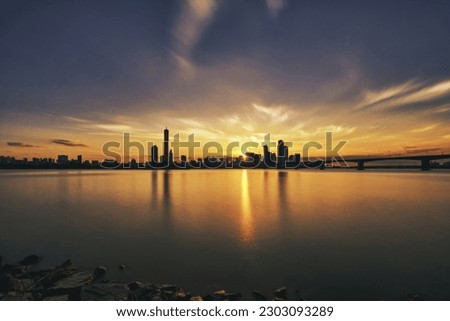 Sunset and silhouette view of 63 Building and high rise buildings of financial district with Wonhyo Bridge on Han River at Yeouido near Yeongdeungpo-gu, Seoul, South Korea
 Royalty-Free Stock Photo #2303093289
