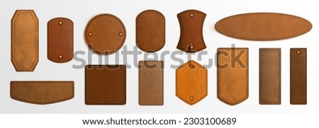 Realistic set of genuine leather labels isolated on white background. Vector illustration of brown material tag for price or quality information about clothes and accessories. Vintage style texture Royalty-Free Stock Photo #2303100689