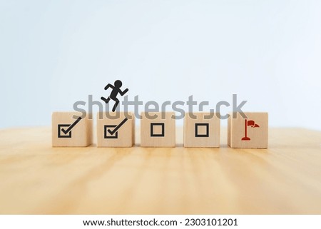 Work in progress concept. Goals, targets, tasks tracking. Goals achievement and business success.  Task completion. Managing project timeline. Wooden blocks with target achievement icon. Royalty-Free Stock Photo #2303101201