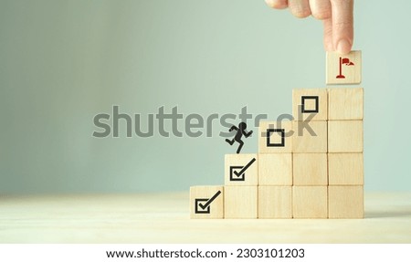 Work in progress concept. Goals, targets, tasks tracking. Goals achievement and business success.  Task completion. Managing project timeline. Wooden blocks with target achievement icon. Royalty-Free Stock Photo #2303101203