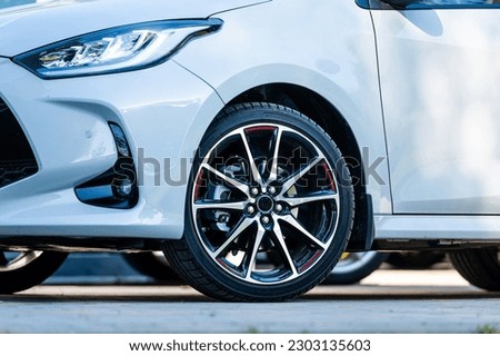 sports car wheels, low profile tires on aluminum rims, close-up, selective focus Royalty-Free Stock Photo #2303135603