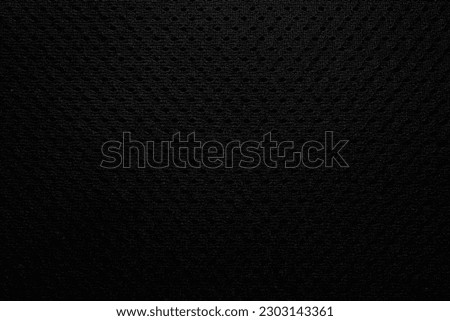 Abstract black fabric texture background or dark grey cloth texture background with vignette effect.