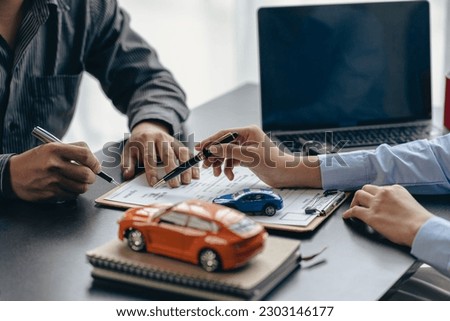 The car dealership allows customers to sign car insurance documents or rental paper. Planning to manage transportation finance costs The concept of car insurance and new car loan business