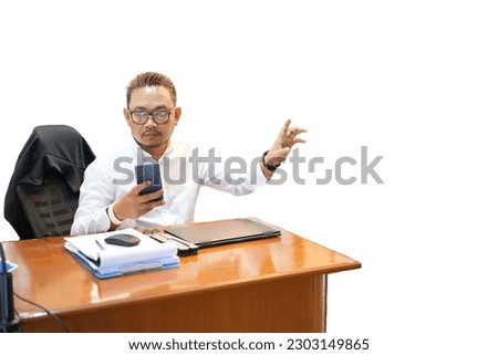 business man looking at the phone on the desk in the office on white background