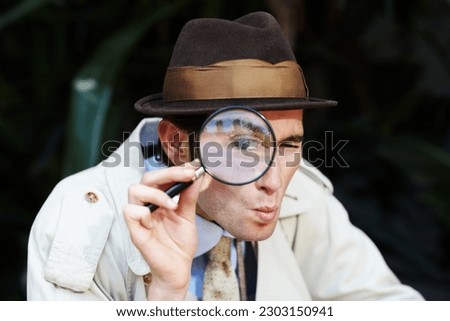 Private investigator, eye in magnifying glass and portrait of man for detective, searching and looking. Spy, investigation and male person with magnifier for secrets, information and mystery clue Royalty-Free Stock Photo #2303150941