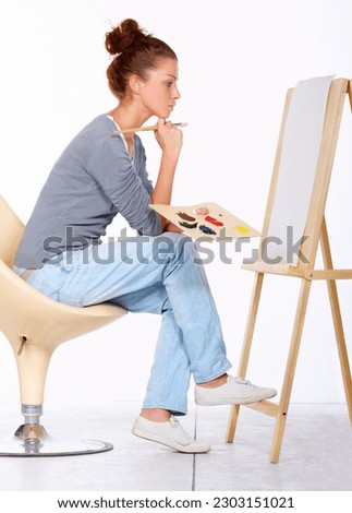 Woman, painting and thinking about art canvas in studio for creativity and talent with paint brush for color. Female artist or painter isolated on a white background for creative work and ideas