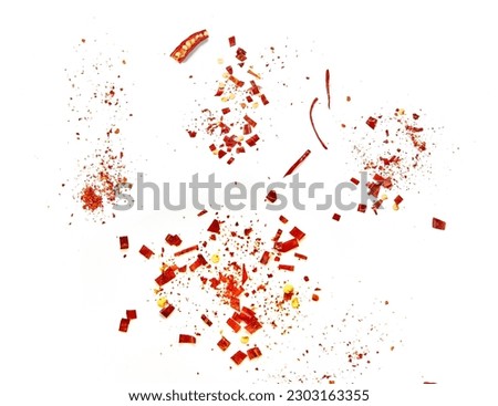 Red chilli flakes, Hot crushed red cayenne pepper flakes scattered over white background.dried chili flakes and seeds  Royalty-Free Stock Photo #2303163355