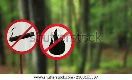No smoking sign and no campfire sign in the forest. Do not smoke outdoors. Protect the environment. Royalty-Free Stock Photo #2303165537